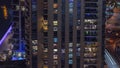 Light in windows of modern towers. Exterior of apartment building at night with glowing windows timelapse. Royalty Free Stock Photo