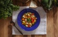 Light winter vegetable soup in blue bowl