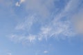 Light wispy cloud formations scattered over vibrant blue sky for clean sky background Royalty Free Stock Photo