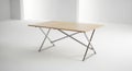 Light wood folding table with metal x frame legs isolated on white background Royalty Free Stock Photo