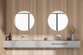 Light wooden bathroom with two sinks and mirrors, parquet floor