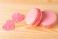 Light wooden board two cakes of pink color and heart, like a background to the day of love Royalty Free Stock Photo