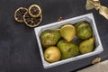 Light wooden container with pears of various species on a black autumn background Royalty Free Stock Photo