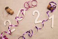 Light wooden 2021 numbers lie on craft paper with champagne corks, packing tape and muzlet Royalty Free Stock Photo