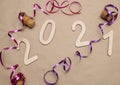 Light wooden 2021 numbers lie on craft paper with champagne corks, packing tape and muzlet Royalty Free Stock Photo