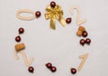 Light wooden numbers 2021 are scattered on a white background in a circle with New Year`s balls, champagne corks and a golden bow