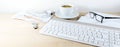 Light wooden office desk in panoramic format with computer keyboard, papers, glasses, usb stick and coffee cup, business at home, Royalty Free Stock Photo