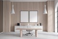 Light wooden and white office with table and posters Royalty Free Stock Photo