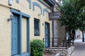 Light yellow brick walls with blue doors and trim inviting guests in, The Smoking Caterpillar, Austin, Texas, 2018