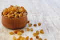 Light yellow raisins in a wooden bowl on a light white background. Close-up. Isolated Royalty Free Stock Photo