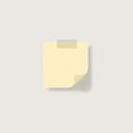 A light yellow sticky note is centered on a plain, light gray background. It appears slig Royalty Free Stock Photo