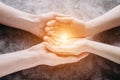 Light in young family hands offering help, protection and support symbol. Royalty Free Stock Photo