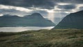 Lightbeams through clouds in sky on Faroe Islands Royalty Free Stock Photo