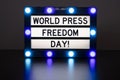 Lightbox with blue lights in dark room with words - world press freedom day