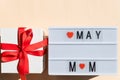 Lightbox and present box. congratulation mothers day.Lightbox with title may and mom on pastel background. Happy Mother