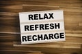 Lightbox or light box with message Reflex Refresh Recharge on a wooden table Royalty Free Stock Photo