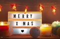 Merry X-mas lightbox and Christmas decorations with candles