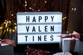 Lightbox with text HAPPY VALENTINES gift boxes on light bokeh background. Saint Valentines Day Royalty Free Stock Photo