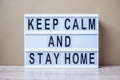 Lightbox with text KEEP CALM AND STAY HOME on table. Coronavirus, Covid-19, Quarantines and Social Distancing concept