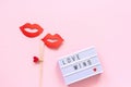 Lightbox with text Love wins and couple paper lips props on stick on pink background. Concept lesbian love National Day