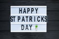 Lightbox with title Happy st Patrick Day on black wooden background. Creative background