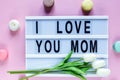 Lightbox with title I love you mom on white wooden table. Mothers day