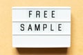 Light box with word free sample on wood background Royalty Free Stock Photo