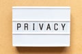 Light box with word privacy on wood background