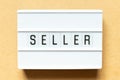 Light box with word seller on wood background Royalty Free Stock Photo