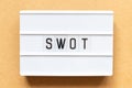 Light box with word swot abbreviation of strength, weakness, opportunities, threats on wood background Royalty Free Stock Photo