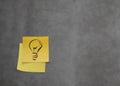 Lightbulb as creative on crumpled sticky note paper on texture w