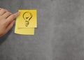 Lightbulb as creative on crumpled sticky note paper