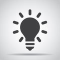 Lightbulb icon with shadow on a gray background. Vector illustration