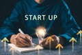 Lightbulb idea, creative mindset, business innovation insight concept shows professional writing strategy in notebook for start up Royalty Free Stock Photo