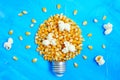 Lightbulb made from sweet corn kernels on blue Royalty Free Stock Photo