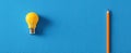 The lightbulb and pencil symbolizing creativity and idea generation on a blue background. AI generated image Royalty Free Stock Photo