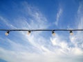 Lightbulb string with sky on background