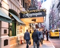 Lighted Algonquin Hotel with crowd of people on sidewalk