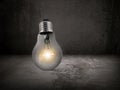 Lighted bulb on Cement floor and concrete old Wall Background Royalty Free Stock Photo