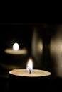 Lighted candle at dark room Royalty Free Stock Photo