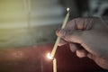 Lighted candle and incense for Buddha. Selective focus. Royalty Free Stock Photo