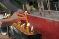 Lighted candle and incense for Buddha. Selective focus. Royalty Free Stock Photo