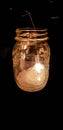 A lighted candle in a jar on night Royalty Free Stock Photo