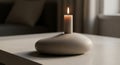 A lighted candle rests on a Royalty Free Stock Photo
