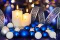 Lighted candles and blue white Christmas tree decorations on the Royalty Free Stock Photo