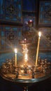 lighted candles stand on a sanctuary lamp in the church, candelabra in an Orthodox church Royalty Free Stock Photo