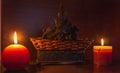 2 lighted candles with a wicker basket behind Royalty Free Stock Photo