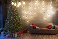 Lighted Christmas tree with presents underneath in living room Royalty Free Stock Photo