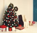 Lighted Christmas tree with presents underneath in living room Royalty Free Stock Photo