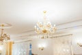 A lighted crystal chandelier under the white ceiling Royalty Free Stock Photo